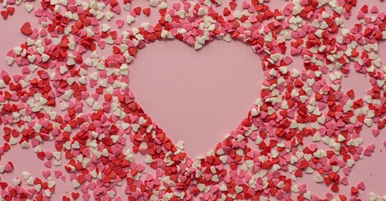 Sentiment - Paper hearts scattered on pink background