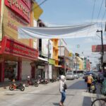 Markets - A street with people walking and bicycles on it