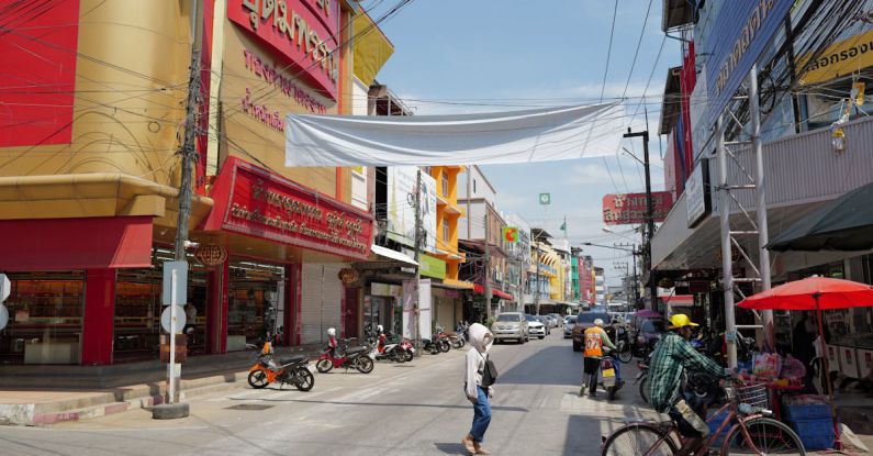 Markets - A street with people walking and bicycles on it