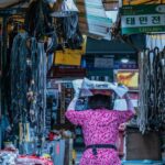 Stocks - Woman Walking on Pathway Between Stores