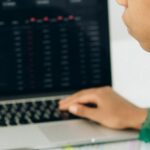 IPOs - Boy in Green and Black Shirt Using Macbook Pro