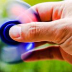 Trends - Person Playing Blue Hand Spinner