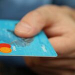 Debt Levels - Person Holding Debit Card