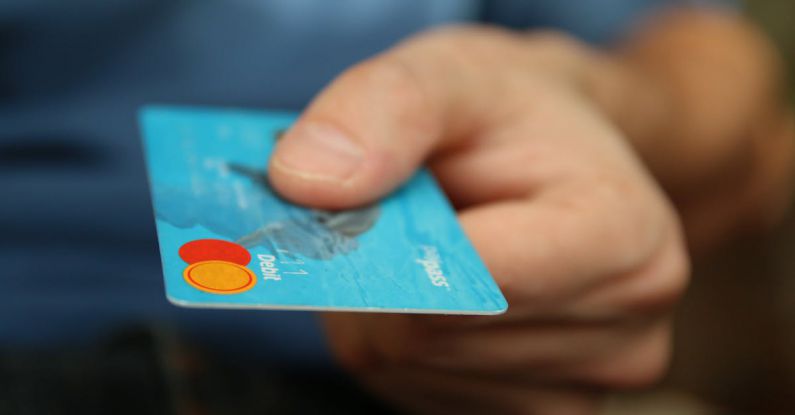 Debt Levels - Person Holding Debit Card