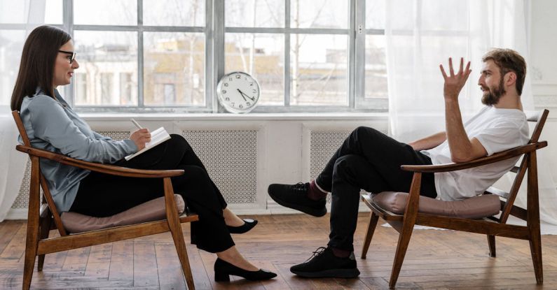 Fundamental Analysis - Person in Black Pants and Black Shoes Sitting on Brown Wooden Chair