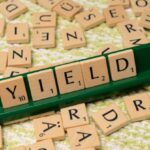 Dividends - A scrabble board with the word yield written on it