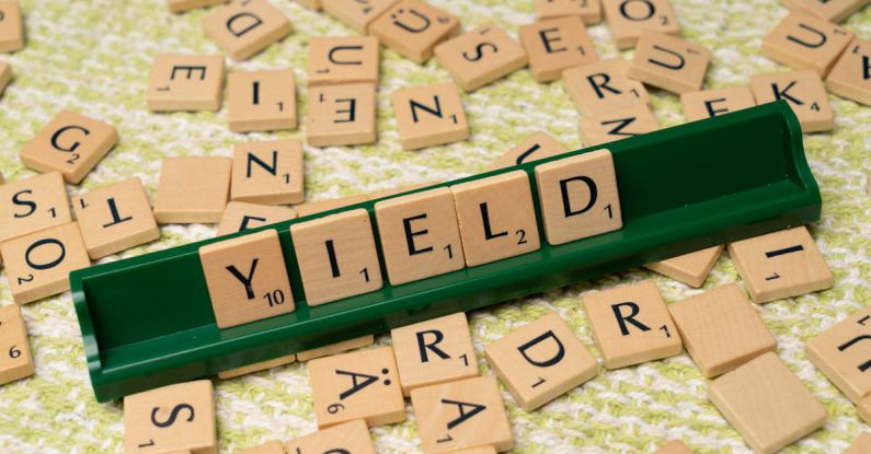 Dividends - A scrabble board with the word yield written on it
